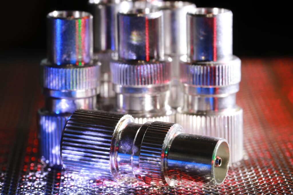 Detailed view of metal connectors with dramatic lighting creating an industrial feel.